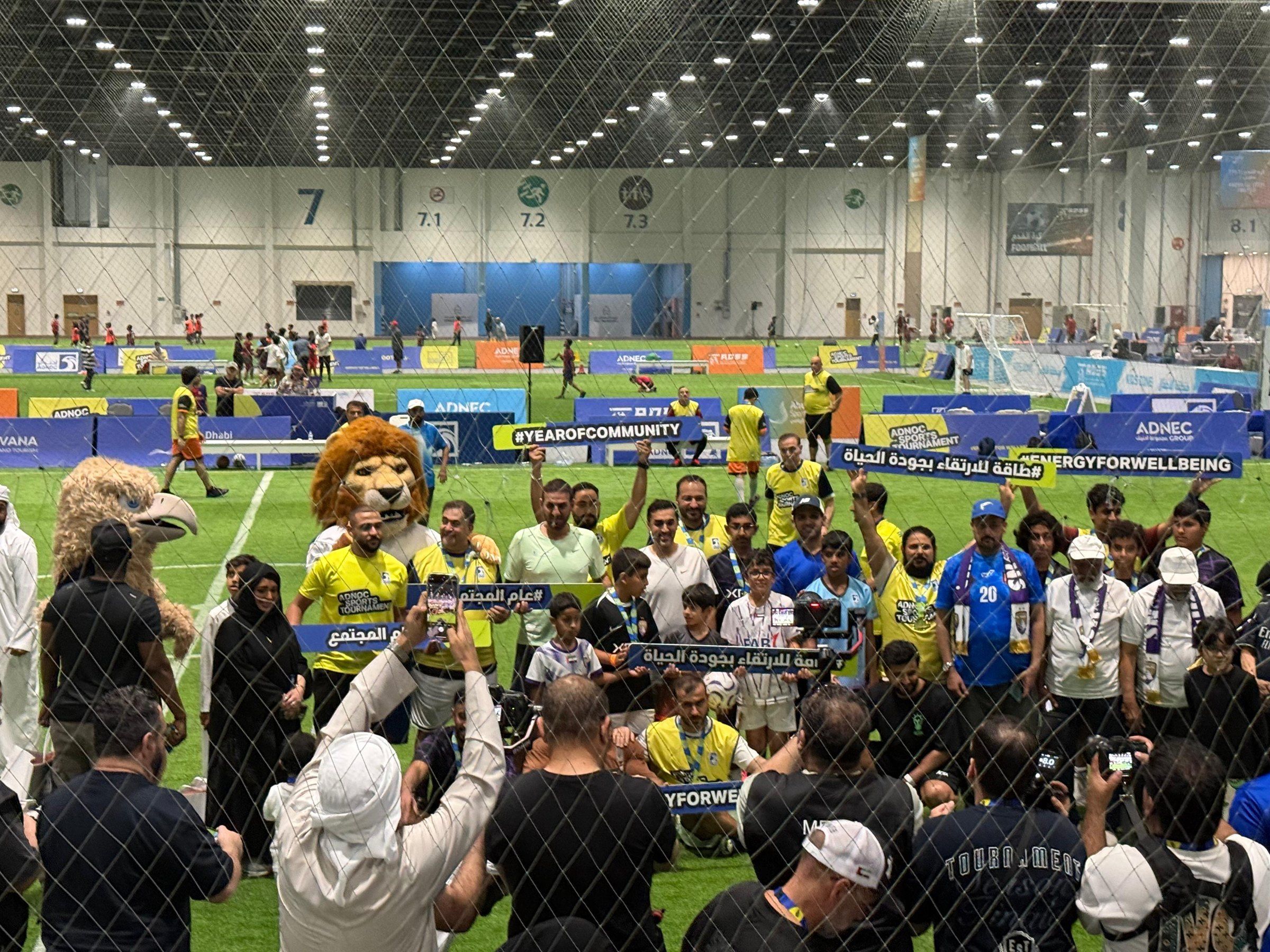 Families and mascots gathered on the indoor pitch at Abu Dhabi Summer Sports